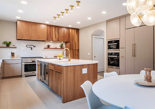 Kitchen with white table, wood-paneled island and wood cabinets set up as part of our full home renovation services near Aldie, VA.
