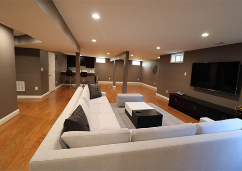 Basement renovation with couches and TV, part of our interior remodeling near Annandale, Virginia.