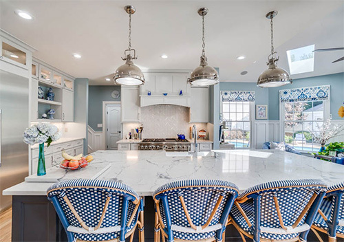 Renovated kitchen with chairs, island, and new cabinets done for kitchen remodeling near Countryside, Sterling, Virginia.