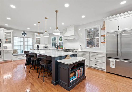 Kitchen renovation with fridge, cabinets, and island installed by our top remodeler near Reston, Virginia.
